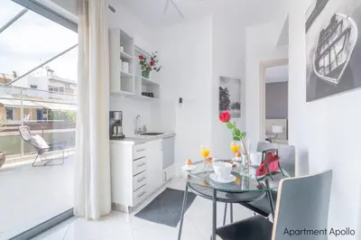 a kitchen and dining room with a glass table at Apollo & Artemis by Heloni Apartments in Athens