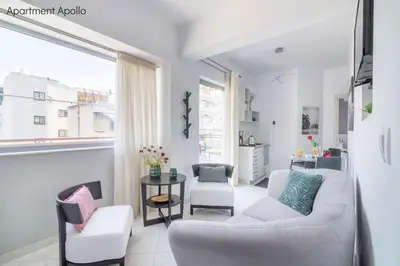 a living room with two chairs and a table at Apollo & Artemis by Heloni Apartments in Athens