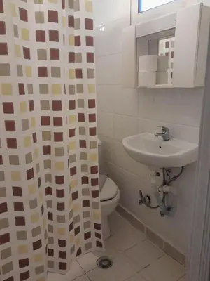 a bathroom with a toilet and a sink at Ikaros in Piraeus