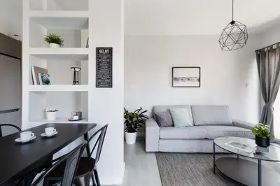 a living room with a couch and a table at Minimal 2BD Apartment with Lycabettus view by UPSTREET in Athens