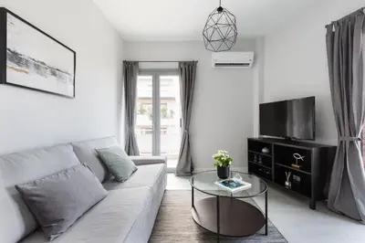 a living room with a couch and a table at Minimal 2BD Apartment with Lycabettus view by UPSTREET in Athens