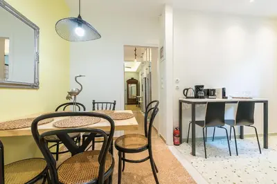 a kitchen and dining room with a table and chairs at Splash Of Glam I 10 steps from Acropolis in Athens