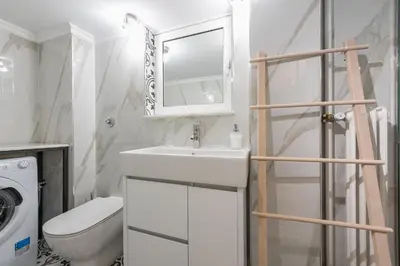a bathroom with a sink and a toilet and a mirror at Splash Of Glam I 10 steps from Acropolis in Athens
