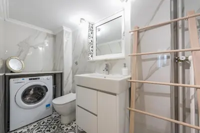 a bathroom with a sink and a washing machine at Splash Of Glam I 10 steps from Acropolis in Athens