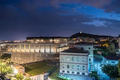 a view of a building in a city at night at Splash Of Glam I 10 steps from Acropolis in Athens