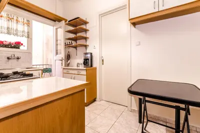 a kitchen with a counter and a stool in it at Petaluda House 3 in Athens