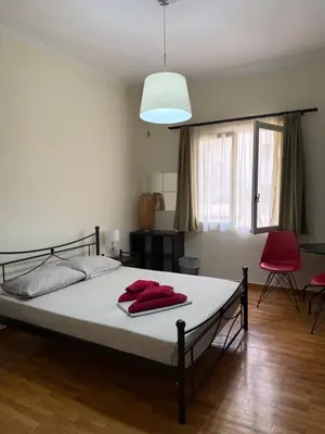 a bedroom with a bed with red towels on it at Petaluda House 3 in Athens