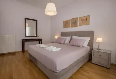 a bedroom with a bed with two towels on it at Familygroupflat in Athens