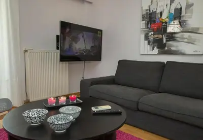a living room with a couch and a coffee table at Familygroupflat in Athens