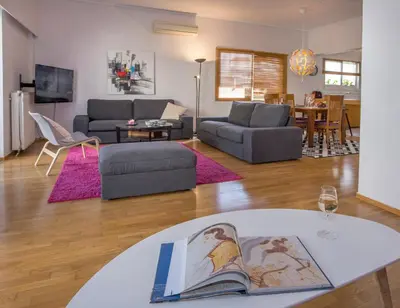 a living room with a couch and a table at Familygroupflat in Athens