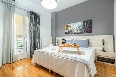 a bedroom with a bed with a tray of fruit on it at Hermes by Heloni Apartments in Athens