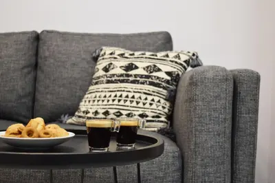 a table with two glasses of beer and a plate of food at Hermes by Heloni Apartments in Athens
