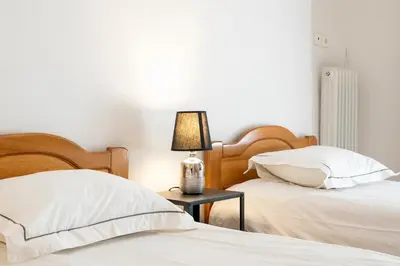 a bedroom with two beds and a lamp on a table at Scent Of Freedom Apartment Renovated in Athens