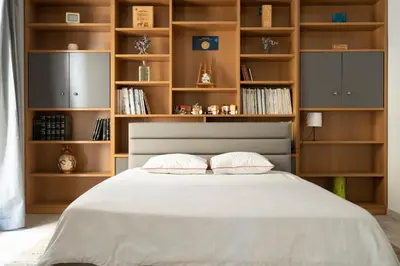 a bedroom with a large white bed with wooden shelves at Scent Of Freedom Apartment Renovated in Athens