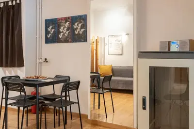 a dining room with a table and chairs and a fireplace at Scent Of Freedom Apartment Renovated in Athens