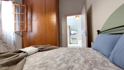 a bedroom with a large bed and a mirror at cozy minimal apartment in Piraeus