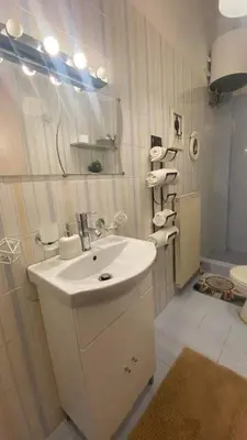 a white bathroom with a sink and a toilet at cozy minimal apartment in Piraeus