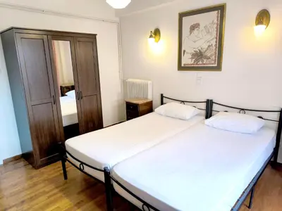 a bedroom with two beds and a picture on the wall at Athens Parrot in Athens