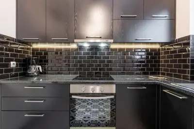a kitchen with black cabinets and a stove at Athens Parrot in Athens