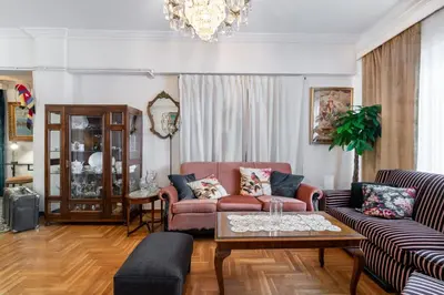 a living room with a couch and a table at Athens Parrot in Athens
