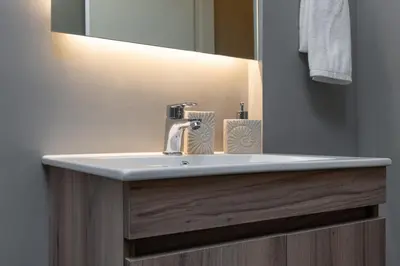 a bathroom with a sink and a mirror at Absolute Athens Apartments in Athens