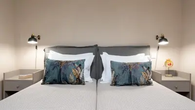 a bedroom with a large bed with two pillows at Absolute Athens Apartments in Athens