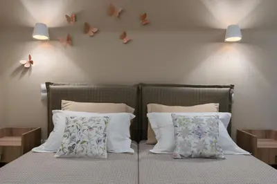 a bedroom with two beds with butterflies on the wall at Absolute Athens Apartments in Athens