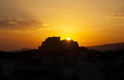 a sunset over the acropolis of athens at sunset at Acropolis View Penthouse N in Athens