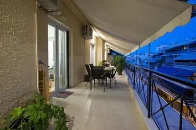 a balcony with a table and chairs in a building at Acropolis View Penthouse N in Athens