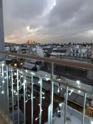 a view from the balcony of a building at night at Acropolis View Penthouse N in Athens