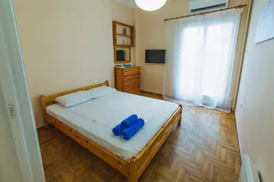 a bedroom with a bed with a blue object on it at VIP Greece Petros in Athens