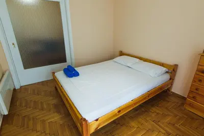 a small bedroom with a bed with a pair of blueippers on it at VIP Greece Petros in Athens