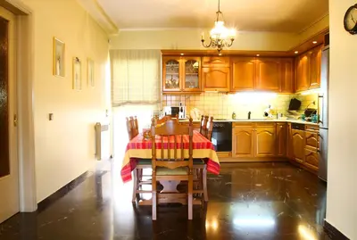 a kitchen with a table with a red and yellow table cloth at Astonishing view in Athens