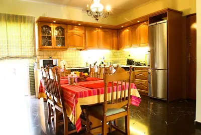 a kitchen with a table with a red and yellow table cloth at Astonishing view in Athens