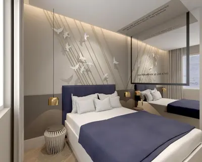 a bedroom with two beds with a blue headboard at Great Living Koukaki in Athens