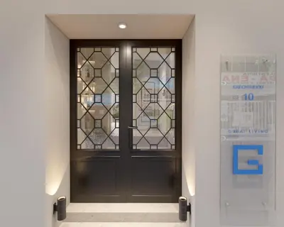a black door with a window in a hallway at Great Living Koukaki in Athens