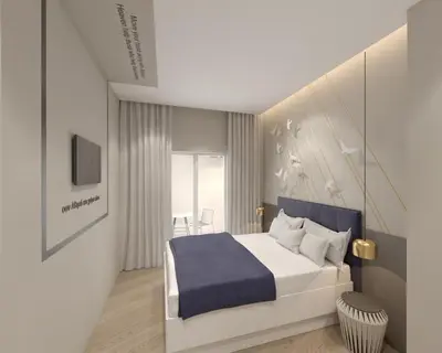 a bedroom with a large white bed with a blue blanket at Great Living Koukaki in Athens