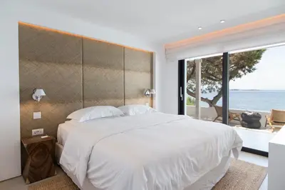 a bedroom with a large bed and a large window at The Margi Villa in Athens