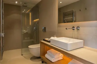 a bathroom with a sink and a toilet and a shower at The Margi Villa in Athens