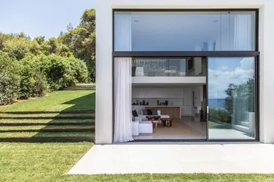 a glass house with a view of the backyard at The Margi Villa in Athens