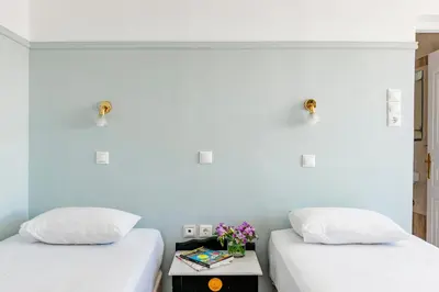 two beds sitting next to each other in a room at Phaedra Hotel in Athens