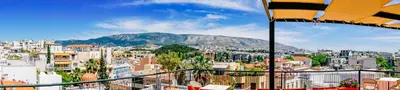 a view of a city with a mountain in the background at Phaedra Hotel in Athens