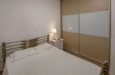 a bedroom with a large white bed with a glass door at Edem BeachFront SeaView Dream Home In Beautiful Athens Riviera in Palaio Faliro in Athens
