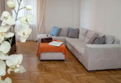 a living room with a couch and a table at Edem BeachFront SeaView Dream Home In Beautiful Athens Riviera in Palaio Faliro in Athens