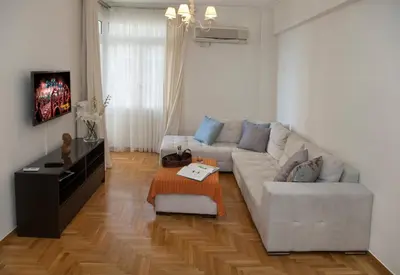 a living room with a couch and a table at Edem BeachFront SeaView Dream Home In Beautiful Athens Riviera in Palaio Faliro in Athens