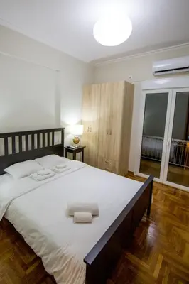 a bedroom with a large bed with two towels on it at Sweet Home VIPGreece in Athens