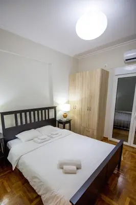 a bedroom with a large bed with two towels on it at Sweet Home VIPGreece in Athens