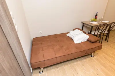 a brown couch in a room with a table at Sweet Home VIPGreece in Athens