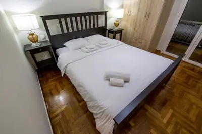 a bedroom with a large bed with two towels on it at Sweet Home VIPGreece in Athens