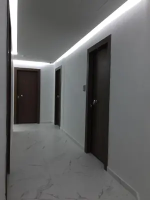 an empty hallway with two doors and a tile floor at Electra & Myrto Apartments in Athens